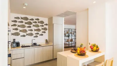 a kitchen with plates on the wall above a counter at Laguna Seaview Penthouse with Rooftop Pool 50 m to Bang Tao Beach in Bang Tao Beach