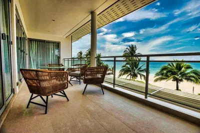 a balcony with tables and chairs and a view of the beach at Laguna Seaview Penthouse with Rooftop Pool 50 m to Bang Tao Beach in Bang Tao Beach