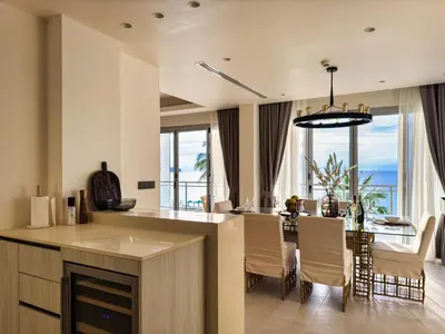 a kitchen and dining room with a view of the ocean at Laguna Seaview Penthouse with Rooftop Pool 50 m to Bang Tao Beach in Bang Tao Beach