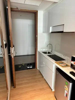 a kitchen with a sink and a counter top at HomeAwayFromHome in Phuket Town