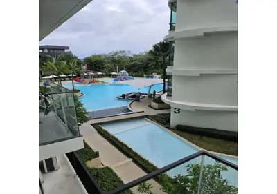 a view of the pool from the balcony of a hotel at HomeAwayFromHome in Phuket Town