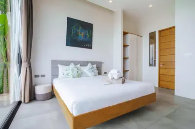 a bedroom with a bed with a teddy bear on it at Lapista 6 Bedroom Luxury Vila in Phuket Town