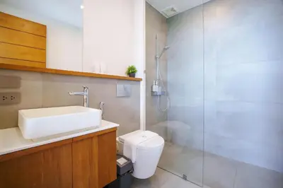 a bathroom with a sink and a toilet and a shower at Lapista 6 Bedroom Luxury Vila in Phuket Town