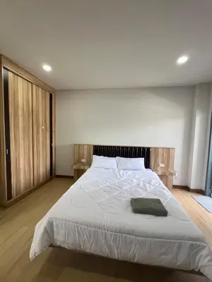 a bedroom with a large bed with white sheets at Nub-Nueng place นับหนึ่ง เพลส in Ban Bo Han