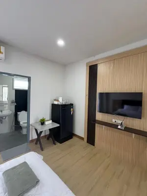 a bedroom with a bed and a tv on a wall at Nub-Nueng place นับหนึ่ง เพลส in Ban Bo Han