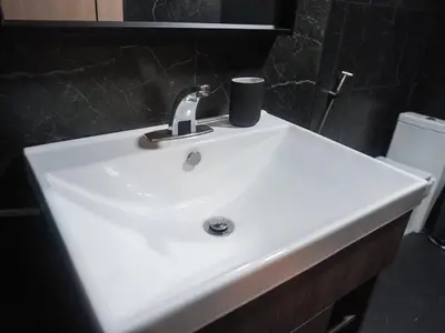 a white sink in a bathroom with a toilet at Nordic Hostel I Female Only I Dorms only in Phi Phi Don