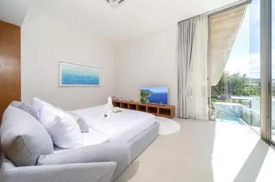 a white bedroom with a bed and a couch at Brand-New & Luxury 5BR Pool Villa Trinity C2 in Bang Tao Beach