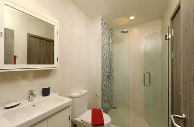 a bathroom with a toilet and a sink and a shower at Mountain View Apart Naiyang Beach in Phuket