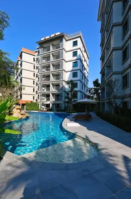 a swimming pool in front of a apartment building at Mountain View Apart Naiyang Beach in Phuket