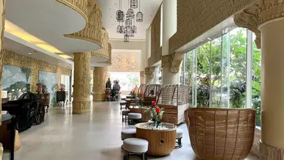 a lobby with chairs and tables in a building at Heritage - Modern Studio shared Pool, City Centre in Patong Beach