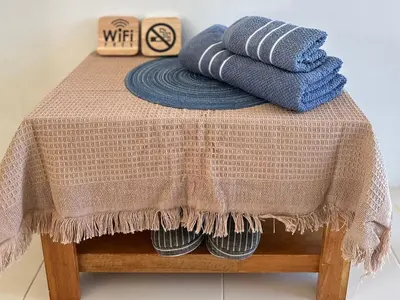 a table with towels on top of a table at Sachi House Stay Near Muay Thai Gym and Beach in Ban Thalat Choeng Thale