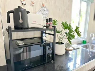 a coffee maker on a cart in a kitchen at Sachi House Stay Near Muay Thai Gym and Beach in Ban Thalat Choeng Thale