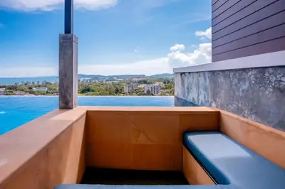 a balcony with a bench and a view of the water at Sea & Mountain View Private Pool Villa at Aonang Beach in Krabi town