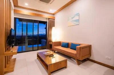 a living room with a couch and a table at Sea & Mountain View Private Pool Villa at Aonang Beach in Krabi town
