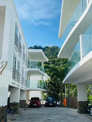 two cars parked in a parking lot in front of a building at Kata Ocean View 1 bedroom Sea View 71 m2 in Kata Beach