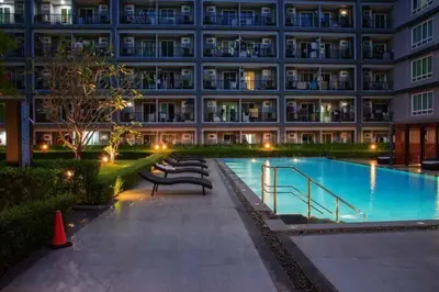 a large building with a swimming pool in front of it at Phuket'in Merkezinde Havuzlu ve Lüks Rezidans in Phuket Town