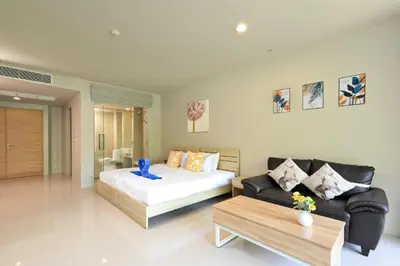 a living room with a bed and a couch at Spacious studio near Karon beach by Pro ARK-204 in Phuket Town