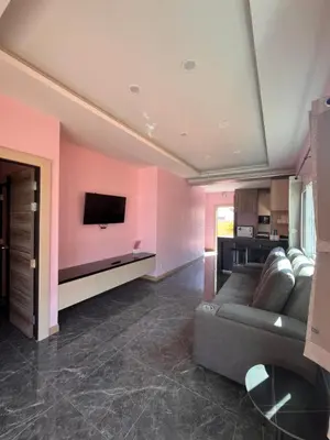 a living room with a couch and a tv at 2 Bedroom Pool Villa in Ban Na Bon