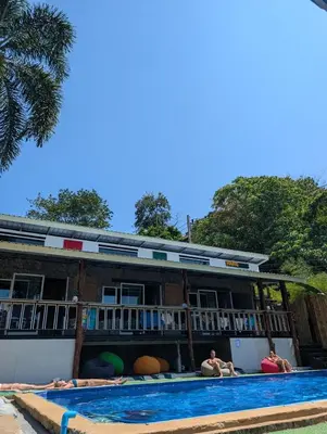 a group of people laying in a swimming pool at Hangover Chill & Hill Hostel in Phi Phi Don