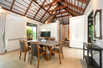 a kitchen and dining room with a table and chairs at Luxurious Villa Near Bangtao Beach in Bang Tao Beach
