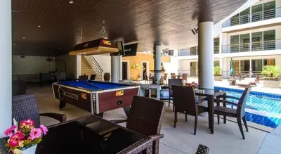 a pool room with a ping pong table and chairs at Large, quiet Condo by รินดา Rinrada in Patong Beach