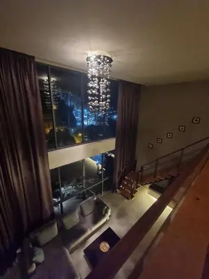 a view of a living room with a chandelier in a building at Penthouse Seaview poolview 140sqm panoramic B43 in Kamala Beach