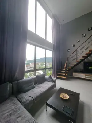 a living room with a couch and a large window at Penthouse Seaview poolview 140sqm panoramic B43 in Kamala Beach