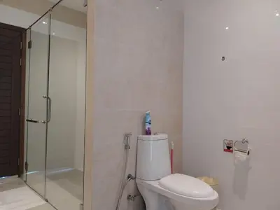 a bathroom with a toilet and a glass shower at Villa Destiny AZ in Ban Saiyuan (1)