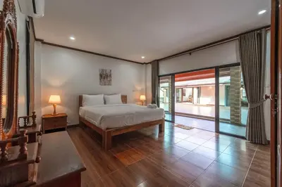 a bedroom with a bed and a large window at V155 4BR Large Family Villa Chalong in Chalong