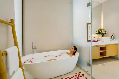 a woman sitting in a bath tub in a bathroom at Elite Living - Design 3BR Pool Villa in Newly Built LuxPride 4 L6 Residence in Bang Tao Beach