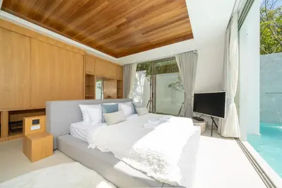 a bedroom with a large bed and a television at Exclusive New Build - Designer 3BR Pool Villa in Prestigious LuxPride 4 L7 Residence in Bang Tao Beach