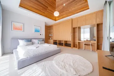 a bedroom with a large bed and a rug at Exclusive New Build - Designer 3BR Pool Villa in Prestigious LuxPride 4 L7 Residence in Bang Tao Beach