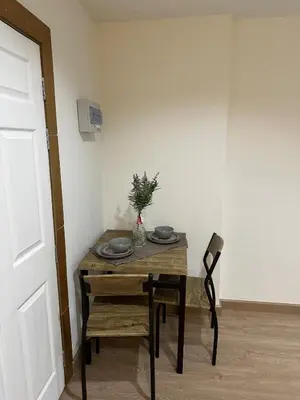 a dining room table and a chair with a vase on it at Luxury Residence in Phuket Center in Phuket Town