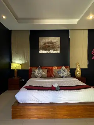 a bedroom with a large bed in a room at 4Bedroom Villa with Private Pool in Ban Klang