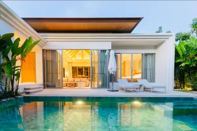 a swimming pool in front of a villa at Trichada Sky 3bed villa, Bangtao, Laguna in Phuket