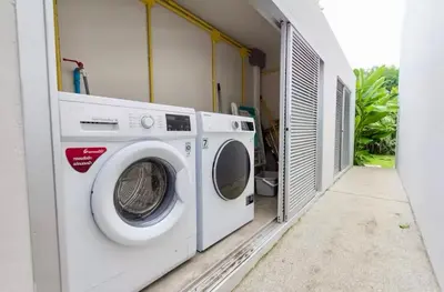a washer and dryer sitting in a laundry room at Trichada Sky 3bed villa, Bangtao, Laguna in Phuket