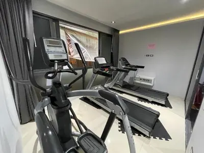 a gym with two tread machines in a room at Emerald Terrace Condo 10-Family One Bed & Sofa Bed Garden View in Patong Beach