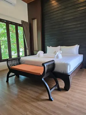 a bedroom with a large bed in a room with windows at Blue Palm Residence Kata in Kata Beach