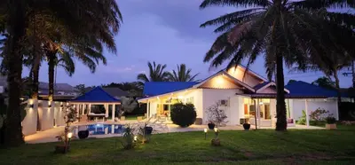 a house with a pool and palm trees in the yard at Villa Valentine Phuket in Ban Thalat Choeng Thale