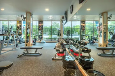 a gym with a lot of treadmills and machines at AZ Sunrise Resort & Fitness Club in Layan Beach