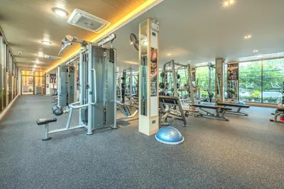 a gym with a lot of treadmills and machines at AZ Sunrise Resort & Fitness Club in Layan Beach