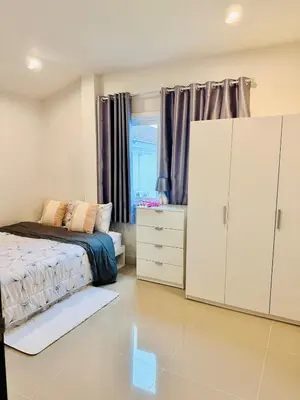 a bedroom with a bed and a dresser at Sirihouse at Supalai Bella Thalang Phuket in Phuket