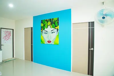 a painting of a woman on a blue wall at Songbird Suites - Deluxe 2 Bedroom, 2 Bathroom Apt in Ban Khlong Haeng