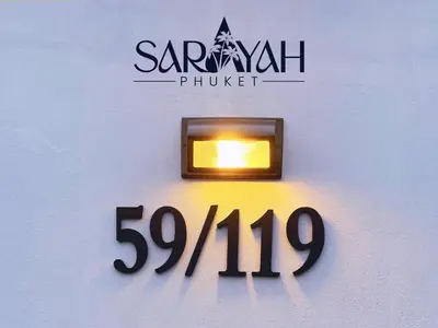 a sign on a wall with a light on it at Sarayah Phuket 4Bed Villa in Ban Tha Rua