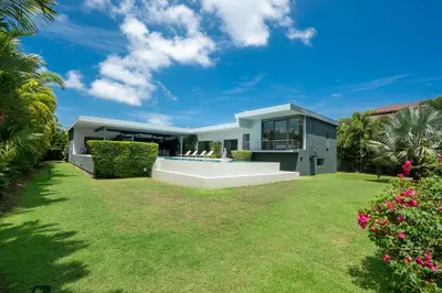 a modern house with a yard at Luxurious 5BR Villa Mayacol with 17m Long Pool, NaiHarn in Rawai Beach