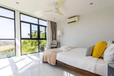 a white bedroom with a bed and large windows at Sunny Stay A8 Charming Residence Close to Nature in Kamala Beach