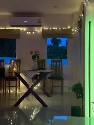 a dining room with a table and chairs and lights at Дом у биг Будды in Ban Klang