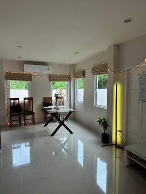 a large living room with a table and chairs at Дом у биг Будды in Ban Klang
