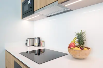 a bowl of fruit on a counter in a kitchen at Himmapana Villas - Grand Valley in Kamala Beach