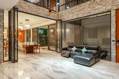 a living room with a leather couch and a table at V158 9BR Tennis On prestigious Phuket Country Club in Kathu